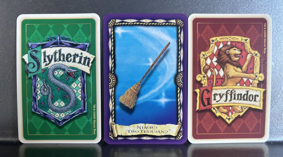 Trivia Game House cards (Slytherin, Gryffindor) and a Charms card (Nimbus Two Thousand)